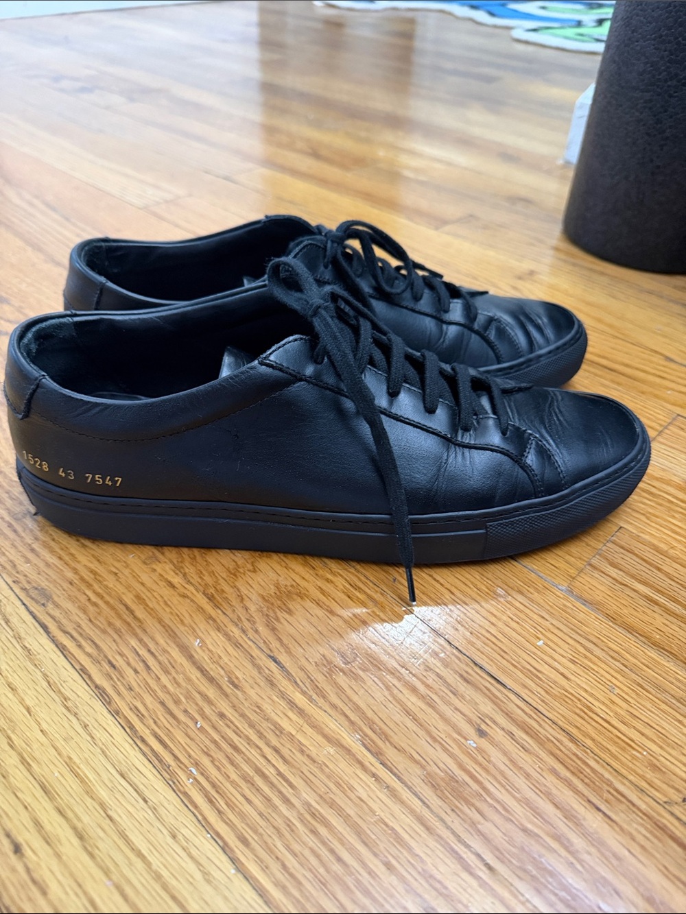 Common Projects Black Leather Low-Top Sneakers with Gold Stamped Detail